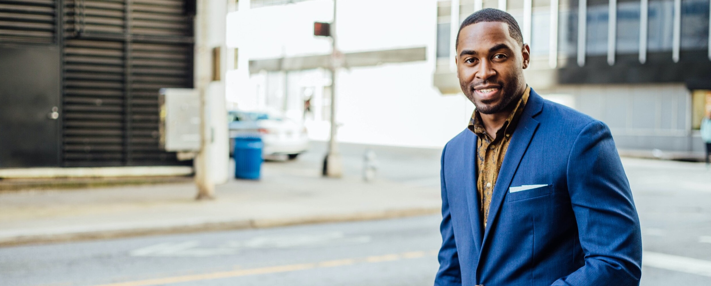 Man in a suit standing on a street